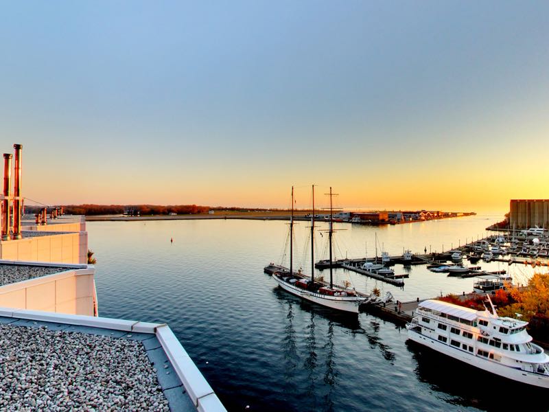 sunset views of toronto Islands and harbour from rooftop deck of 401 queens quay w